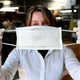 An employee at an Italian leather factory that started producing masks